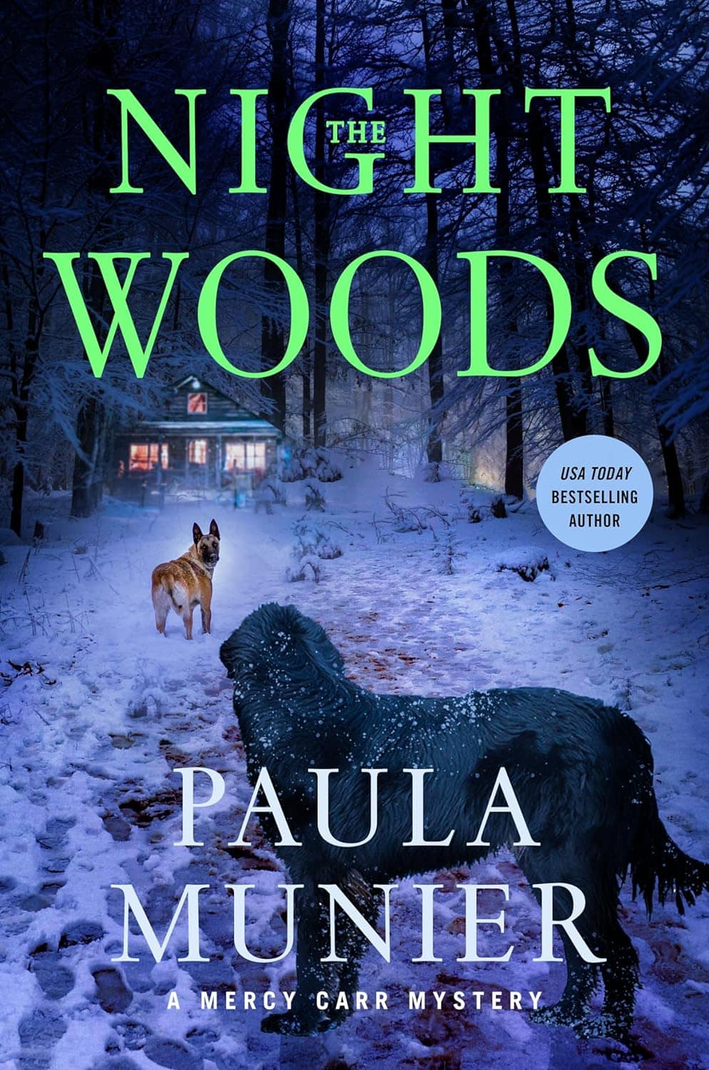 The cover of the book 'The Night Woods' by Paula Munier. The scene depicts a snowy woodland at twilight with a house in the background that has lights on. On the snow-covered path leading to the house, one dog is standing, while another long-haired dog stands prominently in the foreground. Text on the cover includes 'A Mercy Carr Mystery' and 'USA Today Bestselling Author.'